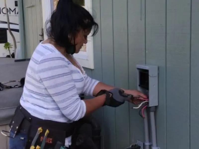 Licensed electrician wiring an exterior subpanel in Southeast