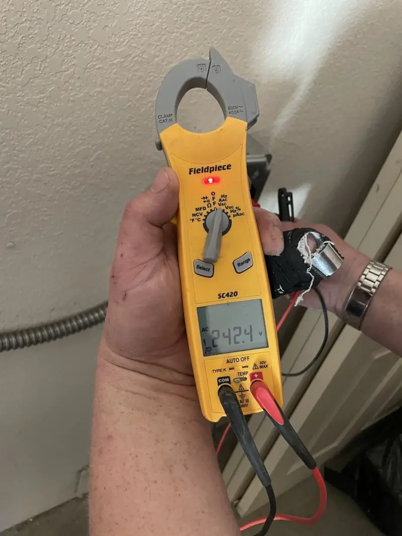 Voltage testing with clamp meter during Ceiling Fan Installation in Southeast
